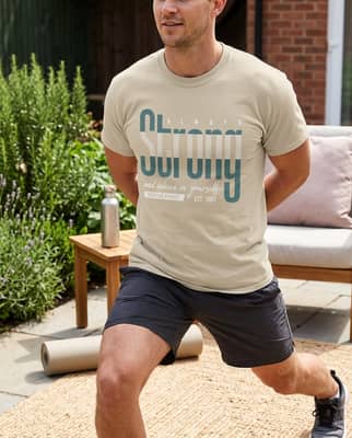 Person in a short-sleeve t-shirt stretching on a sunny backyard patio next to a yoga mat and water bottle.